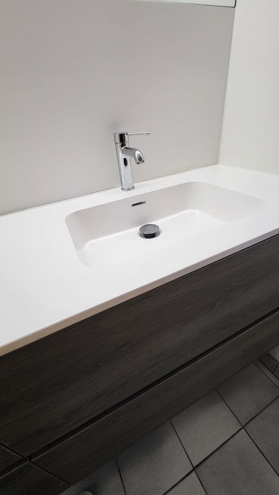 Détail d’une vasque intégrée et de sa robinetterie